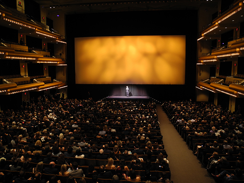 Screen and stage setup for a presentation at David Geffen Hall in Manhattan, NY.